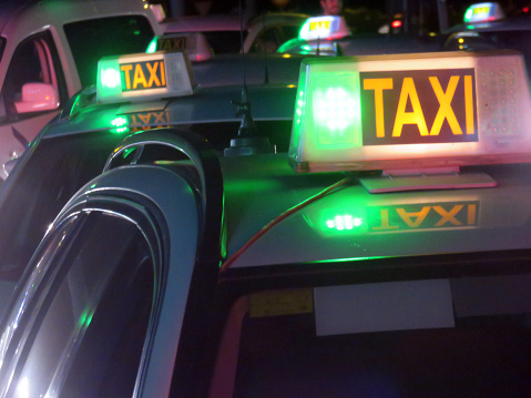 Lots of taxis Waiting at the exit of a nightclub
