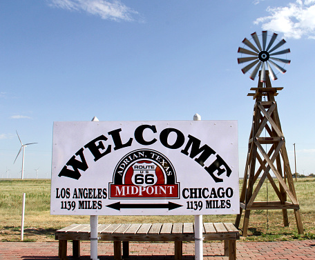 Historic route 66 sign showing the midpoint between Los Angeles and Chicago