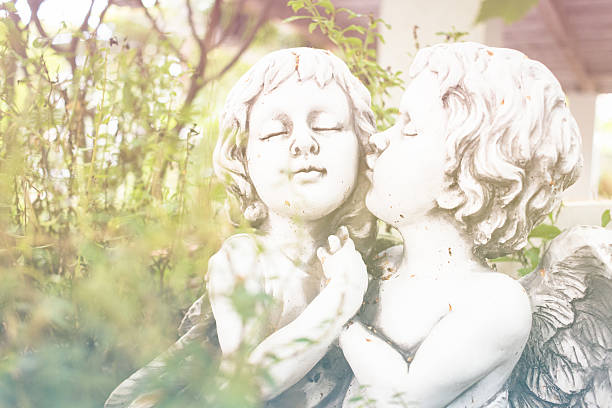 istock Angel Cupid ,White plaster figurine in the garden 583810464