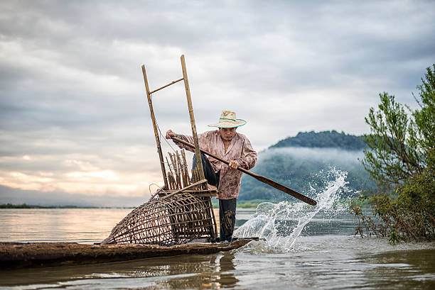 istock Fisherman on boat in action when fishing 583811010