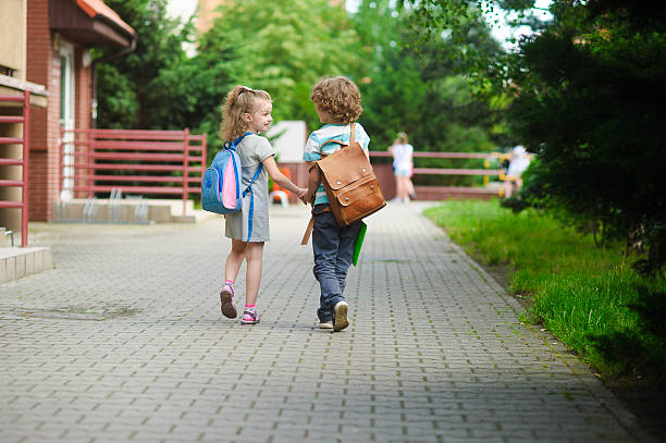 istock Young students, boy and girl, going to school 583811068