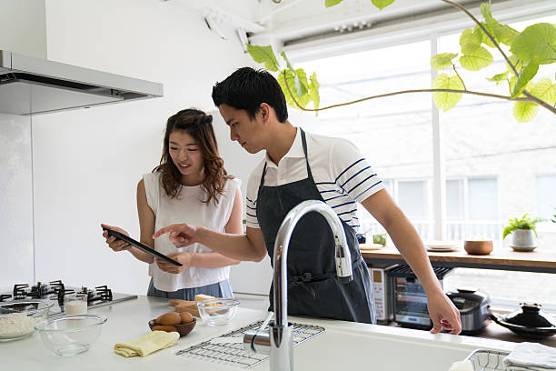 istock Young couple cooking together in a modern kitchen 583811714