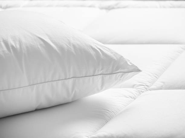 Closeup of white pillow on the bed in the bedroom Closeup of white pillow on the bed in the bedroom duvet stock pictures, royalty-free photos & images