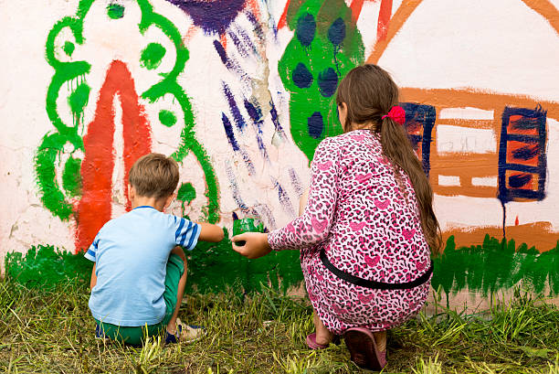 istock children draw a picture on the wall 583812608