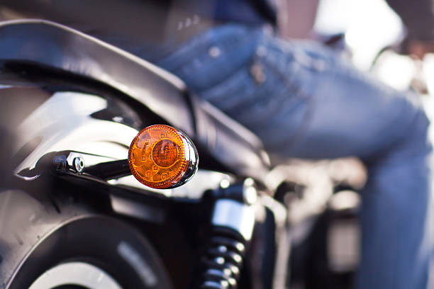 Round yellow motorcycle turning signal.