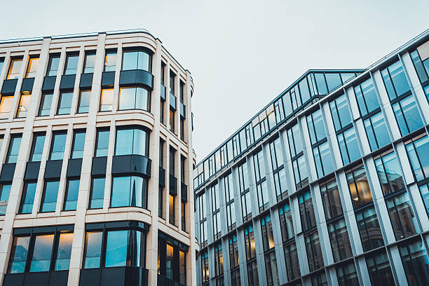 istock Modern office buildings with lights on during day 583813430
