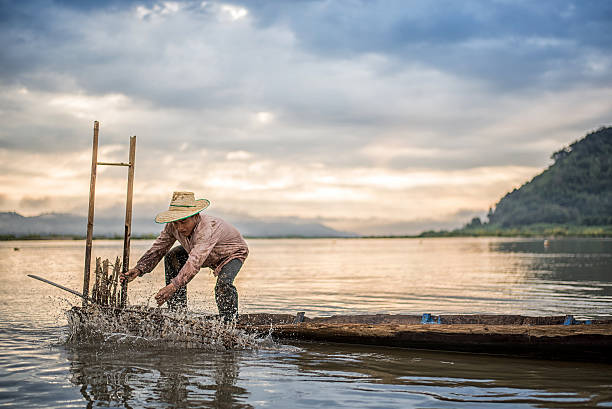 istock Fisherman on boat in action when fishing 583813700