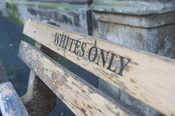 Whites only sign on a bench stock photo