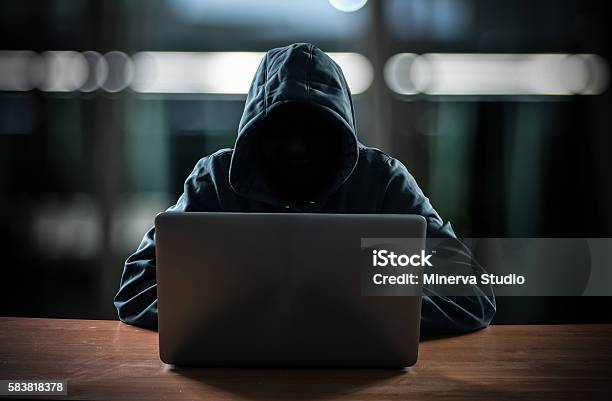 Hacker In Front Of His Computer Stock Photo - Download Image Now - Computer Hacker, Computer Crime, Laptop