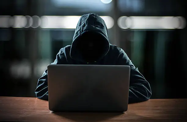 Photo of Hacker in front of his computer