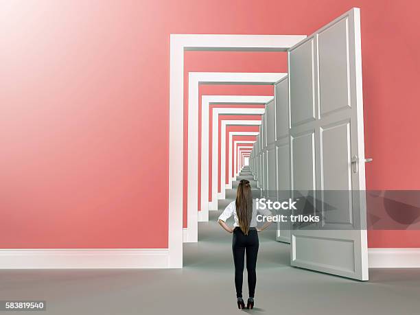 Rear View Of A Businesswoman Standing In Front Of Door Stock Photo - Download Image Now