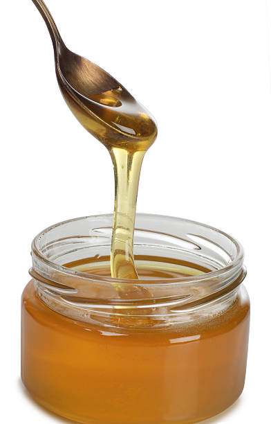istock Honey in glass on white 583819734
