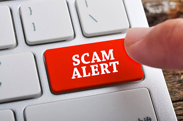 Finger at "SCAM ALERT" On Keyboard Button Finger at "SCAM ALERT" On Keyboard Button hoax stock pictures, royalty-free photos & images