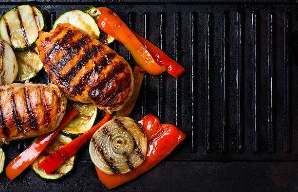 istock Barbecue grilled chicken and vegetables on cast iron table 583823694