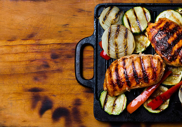 istock Barbecue grilled chicken and vegetables on wooden background 583823986