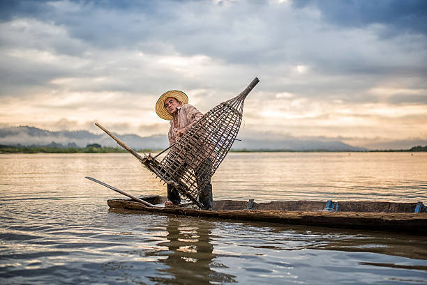 istock Fisherman on boat in action when fishing 583829102