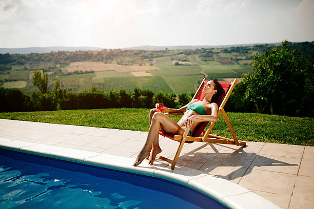 istock Glamorous woman tanning 583829482