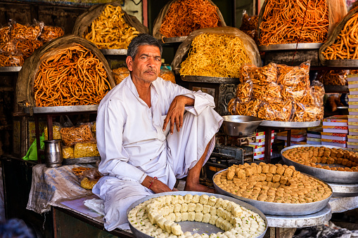 Indian street vendor selling sweets near Jaipur. Jaipur is the capital city of Rajasthan. Jaipur is known as the Pink City, because of the color of the stone exclusively used for the construction of all the structures.