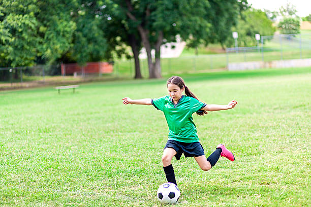 istock Young soccer player runs and kicks ball 583830334