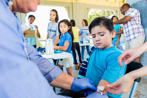 istock Upset hispanic boy getting a flu shot at free clinic 583830548