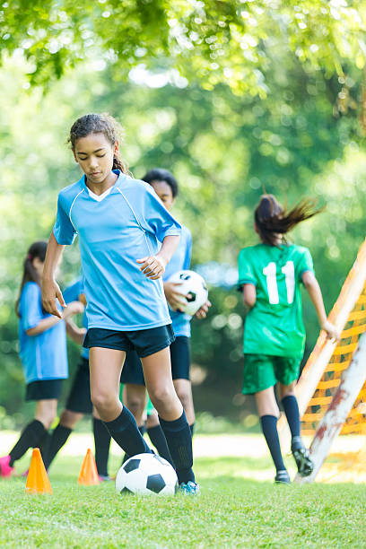 istock Girls soccer team doing warm ups before a game 583831622