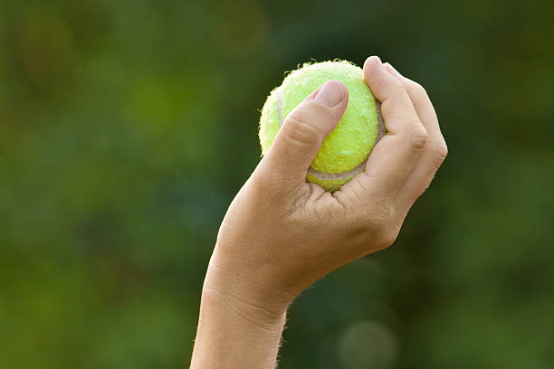istock hand holding tennis ball 583833856