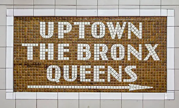 Sign pointing toward uptown Manhattan, the Bronx and Queens.