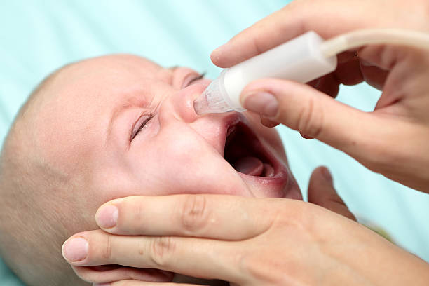 istock Mother cleaning mucus catarrh 583838854