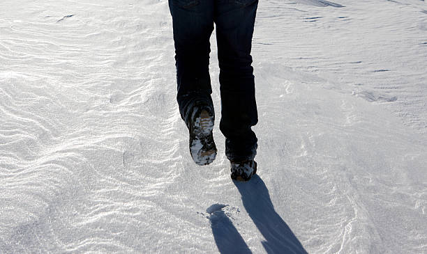 istock Man walking in the snow 583844056
