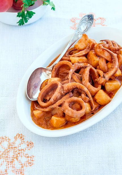 Calamari with Potatoes(Totani e patate). Rustic Italian food, cooking. stock photo