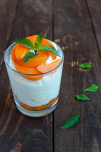 istock Summer cottage cheese dessert with fresh apricots. 583847242