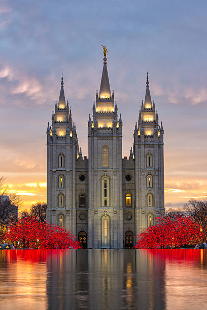 Salt Lake City Utah Temple The Salt Lake City Utah Temple during the holidays at sunset in front of a reflection pond. mormonism stock pictures, royalty-free photos & images