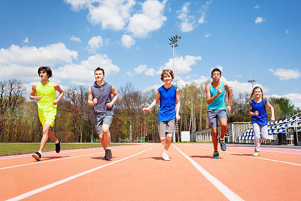 istock Five teenage sprinters running together on a track 583849498