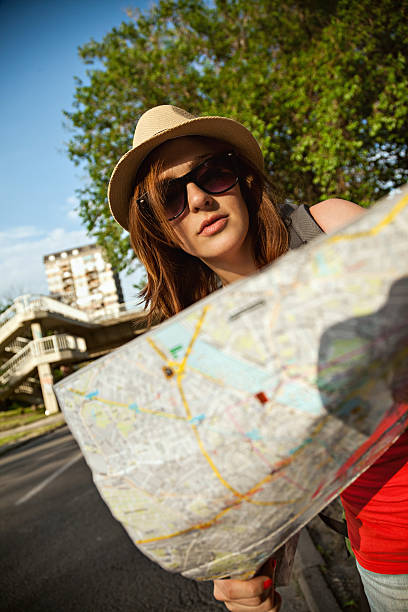 istock Tourist Girl Browsing Map 583850344