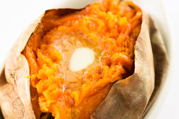 istock baked sweet potato with melted butter selective focus 583850944