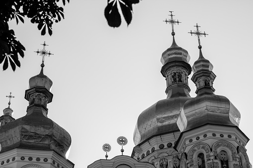 Golden tops and crosses of Christian Orthodox Abbey. Black&white photo
