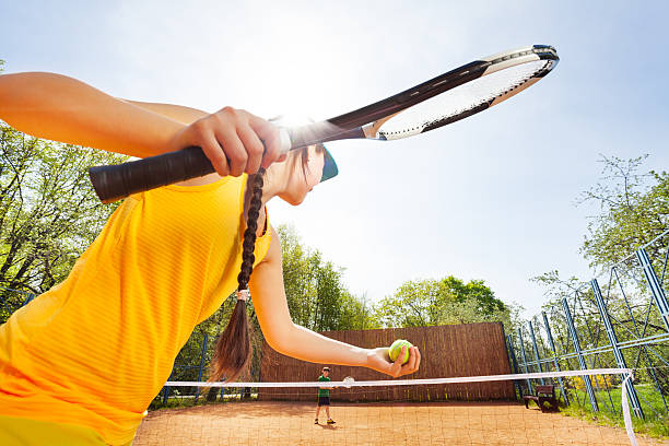 istock Low angle view of tennis player against blue sky 583854016
