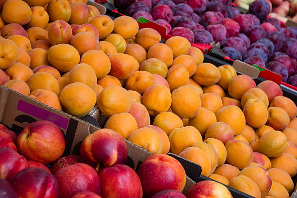 istock fruit market closeup - peaches, nectarines and plums 583854060