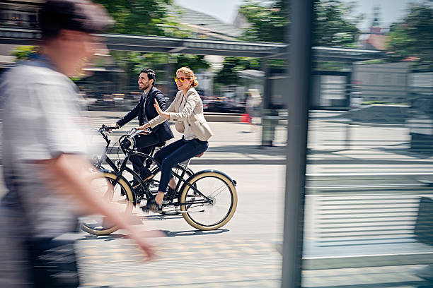 istock two business people riding bicycle 583855198
