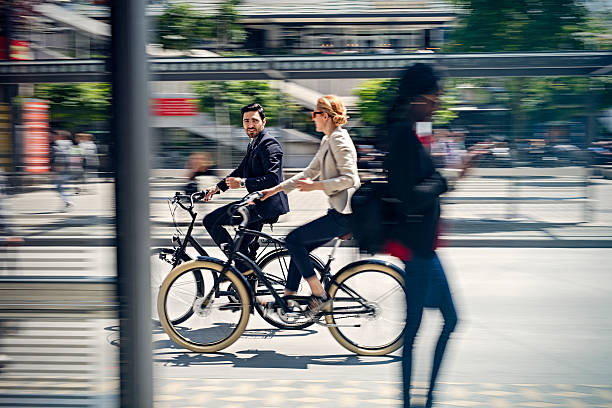 istock two business people riding bicycle 583855224