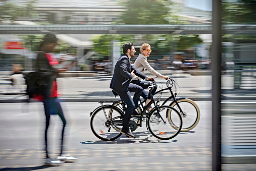 two business people riding bicycle