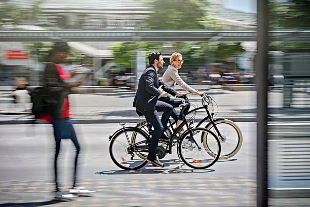 two business people riding bicycle stock photo