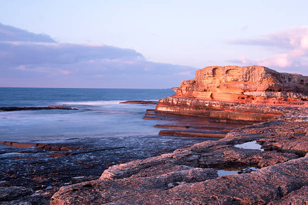 istock Long exposure shot on amazing rocks and sea waves 583855820