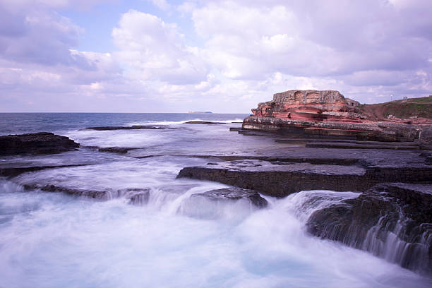 istock Long exposure shot on amazing rocks and sea waves 583856374