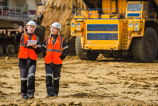 Two people working Man and woman working in an open-pit mining natural resources photos stock pictures, royalty-free photos & images