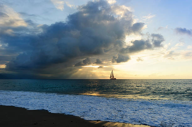 帆船シルエット - stormy sunrise ストックフォトと画像