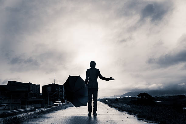 istock businessman are holding an umbrella, dark image 583861574