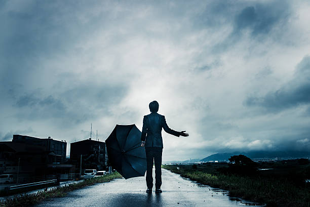 istock businessman are holding an umbrella, dark image 583861592