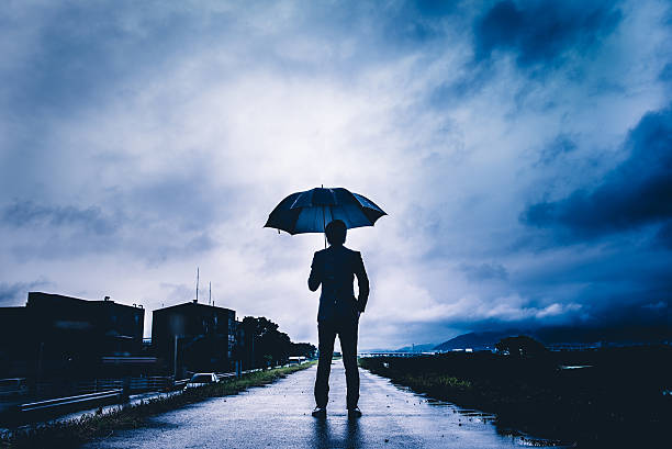 istock businessman are holding an umbrella, dark image 583861656