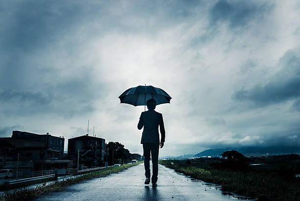 istock businessman are holding an umbrella, dark image 583861668
